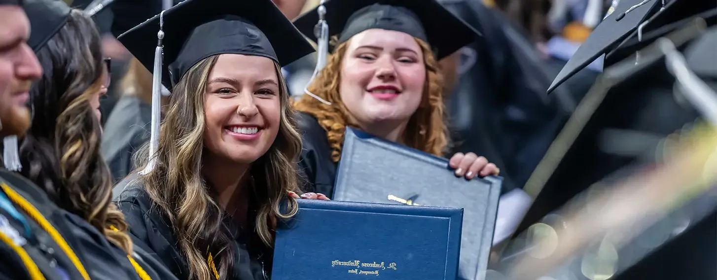 Happy graduates stand together for a photo during their commencement celebration.